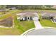 Aerial view of a modern single-story home with manicured lawn and clean white fence at 185 Heritage Park Ln, Mulberry, FL 33860