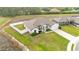 Beautifully landscaped, single-story home featuring a well-maintained lawn and a white fence for added privacy at 185 Heritage Park Ln, Mulberry, FL 33860