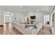 Open-concept living room with modern decor, white sofa, and wood-look flooring at 185 Heritage Park Ln, Mulberry, FL 33860