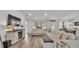 Bright living room with a view into the dining area, wood-look flooring, and comfortable seating at 185 Heritage Park Ln, Mulberry, FL 33860