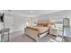 Bright main bedroom with large windows, light-colored furniture, and a comfortable carpet at 185 Heritage Park Ln, Mulberry, FL 33860