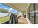 Covered patio with a grill overlooking the backyard with a fence and playground set at 185 Heritage Park Ln, Mulberry, FL 33860