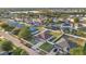 Aerial view of a home with lush landscaping in a friendly neighborhood with a lake at 1925 Binnacle St, Kissimmee, FL 34744