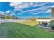 Expansive backyard with manicured lawn, white fencing, and outdoor seating area offers relaxation at 1925 Binnacle St, Kissimmee, FL 34744
