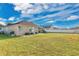 Expansive backyard featuring a well-manicured lawn, patio area, and a secure white fence at 1925 Binnacle St, Kissimmee, FL 34744