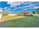 Large backyard featuring lush lawn, fencing, mature trees, and a patio area for outdoor enjoyment at 1925 Binnacle St, Kissimmee, FL 34744