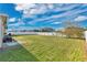 Spacious, grassy backyard enclosed by a white fence, providing ample room for recreation at 1925 Binnacle St, Kissimmee, FL 34744