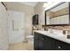 Bathroom featuring a sleek vanity, decorative mirror, and a combination of modern and classic design at 1925 Binnacle St, Kissimmee, FL 34744