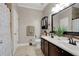 Bathroom with double sink vanity, dark wood cabinets, decorative mirror and tiled backsplash at 1925 Binnacle St, Kissimmee, FL 34744