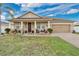 Charming single-story home with a well-manicured lawn and inviting front porch seating area, perfect for relaxing at 1925 Binnacle St, Kissimmee, FL 34744