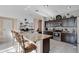 Well-equipped kitchen with a large island, stainless steel appliances, dark cabinetry, and ample counter space for cooking at 1925 Binnacle St, Kissimmee, FL 34744