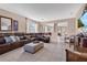 Spacious living room with tile floors, large leather sectional, and view to the dining area, perfect for entertaining at 1925 Binnacle St, Kissimmee, FL 34744