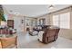 Bright living room featuring neutral walls, tile flooring, comfortable seating, and natural light from large windows at 1925 Binnacle St, Kissimmee, FL 34744