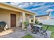 Inviting outdoor patio featuring a dining set, grill, and lush landscaping is ideal for entertaining at 1925 Binnacle St, Kissimmee, FL 34744