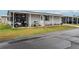 Charming single-story home with a well-maintained lawn, golf cart, and covered parking at 2055 S Floral Ave # 269, Bartow, FL 33830