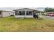 Exterior of home with attached porch/carport and a green lawn at 2055 S Floral Ave # 269, Bartow, FL 33830