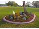 Lush landscaping showcasing a decorative butterfly feature and colorful floral arrangement at 2085 Long Boat Dr, Lakeland, FL 33810