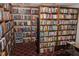 Extensive library space showcasing floor-to-ceiling bookshelves filled with a diverse collection of books at 2085 Long Boat Dr, Lakeland, FL 33810