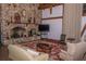 Cozy living room featuring a stone fireplace and comfortable seating arrangements at 2085 Long Boat Dr, Lakeland, FL 33810