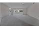 Light-filled living space with neutral carpeting, an open layout, and seamless transition into the dining area at 2085 Long Boat Dr, Lakeland, FL 33810