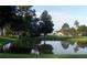 Scenic pond reflecting the surrounding trees and sky, creating a serene setting at 2085 Long Boat Dr, Lakeland, FL 33810