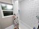 Bathroom features subway tile shower with a floral shower curtain and a bright window at 219 Ariana St # A-B, Lakeland, FL 33803