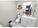 Functional bathroom with toilet, vanity, sink, mirror and wall decorations at 219 Ariana St # A-B, Lakeland, FL 33803
