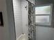 Bathroom featuring a shower with white subway tile, a shower curtain, and a window at 219 Ariana St # A-B, Lakeland, FL 33803