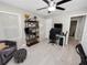 This bedroom has two entryways with light wood floors, a ceiling fan and some furniture at 219 Ariana St # A-B, Lakeland, FL 33803