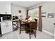 Bright dining area featuring a round wood table, black chairs, and a modern eat-in kitchen at 219 Ariana St # A-B, Lakeland, FL 33803