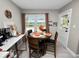 Cozy dining area featuring a round wood table, dark wood chairs, and a large window with natural light at 219 Ariana St # A-B, Lakeland, FL 33803