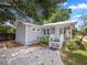Charming gray home featuring a spacious front yard and inviting covered porch at 219 Ariana St # A-B, Lakeland, FL 33803