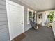 Cozy front porch featuring hammock, neutral siding, bright white trim, and plants at 219 Ariana St # A-B, Lakeland, FL 33803