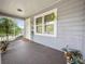 Picturesque porch view featuring neutral siding, bright white trim, and decorative plants at 219 Ariana St # A-B, Lakeland, FL 33803