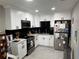 Modern kitchen features white cabinets, black subway tile backsplash, and stainless steel appliances at 219 Ariana St # A-B, Lakeland, FL 33803