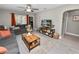 Comfortable living room with gray sofas, wood accents, a ceiling fan, and a view to the front of the home at 219 Ariana St # A-B, Lakeland, FL 33803