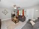 Inviting living room featuring gray sofas, wood coffee table, and a glimpse into the dining area at 219 Ariana St # A-B, Lakeland, FL 33803