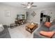 Open-concept living room with gray sofas, a wood coffee table, and a view to the kitchen at 219 Ariana St # A-B, Lakeland, FL 33803