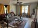 Inviting living room with a plush sofa, area rug, and natural light streaming through the windows at 219 Ariana St # A-B, Lakeland, FL 33803