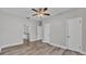 Main bedroom featuring a ceiling fan, wood-look vinyl floors, and ensuite bathroom access at 2203 Avenue F Nw, Winter Haven, FL 33880