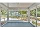 View from the screened porch showcases the backyard and green surroundings, perfect for relaxing at 2203 Avenue F Nw, Winter Haven, FL 33880