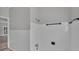This shower includes sleek, white tiling with a modern shower head and updated fixtures at 2203 Avenue F Nw, Winter Haven, FL 33880