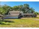 Property featuring lush backyard with screened in pool and shed at 2319 D R Bryant Rd, Lakeland, FL 33810