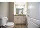 This bathroom features a toilet, vanity with drawers, and a mirror with lighting at 2319 D R Bryant Rd, Lakeland, FL 33810