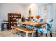 Bright dining room features a wooden table with tropical-patterned chairs and bench seating at 2319 D R Bryant Rd, Lakeland, FL 33810