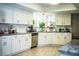 Bright kitchen features white cabinetry, stainless steel appliances and a garden window at 2319 D R Bryant Rd, Lakeland, FL 33810