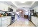 Bright kitchen features white cabinets, stainless steel appliances, and views into the dining area at 2319 D R Bryant Rd, Lakeland, FL 33810