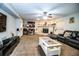 Spacious living room with a fireplace, ceiling fan, and comfortable seating at 2319 D R Bryant Rd, Lakeland, FL 33810