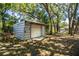 Outdoor storage shed nestled among mature trees on a well-maintained lot at 2319 D R Bryant Rd, Lakeland, FL 33810
