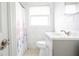 Clean bathroom with white marble tiling, modern vanity, and shower/tub combination at 2332 S Crystal Lake Dr, Lakeland, FL 33801
